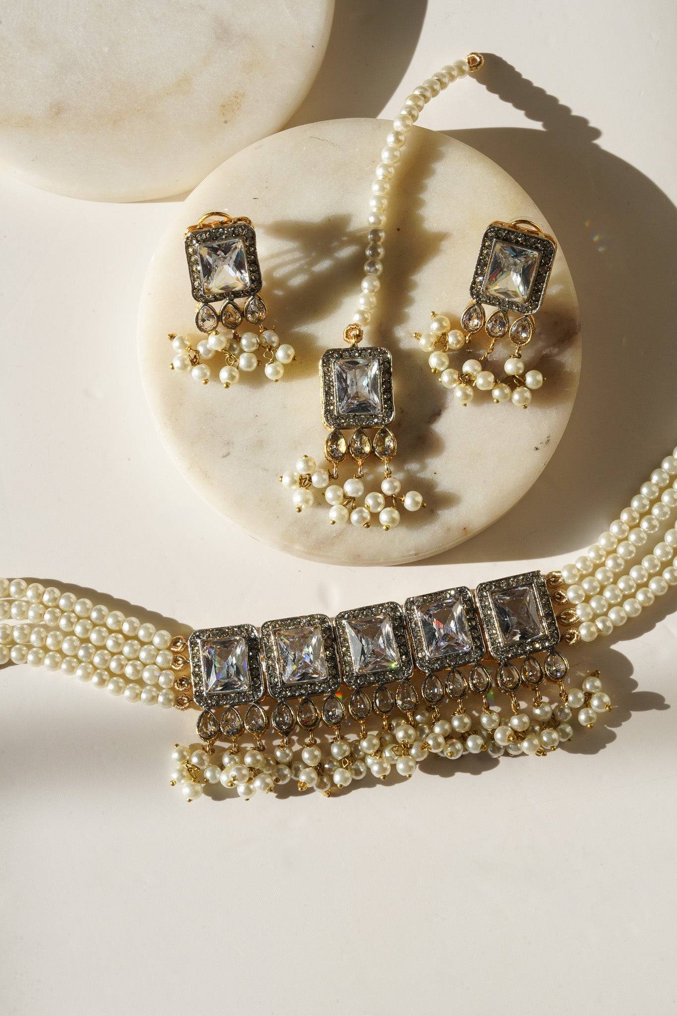 Jahanara Gold Plated Choker Necklace Set - Artisan crafted with cushion cut center stones, zircon rims, teardrop accents, 1.5" earrings, and a charming maang tikka.