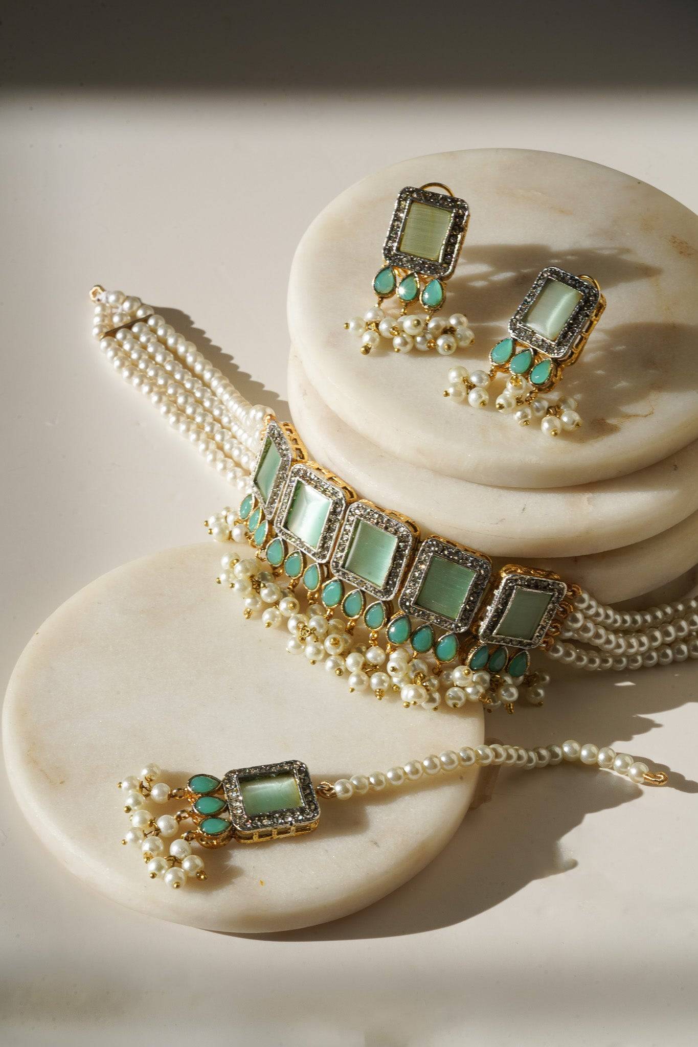 Jahanara Gold Plated Choker Necklace Set - Artisan crafted with cushion cut center stones, zircon rims, teardrop accents, 1.5" earrings, and a charming maang tikka.