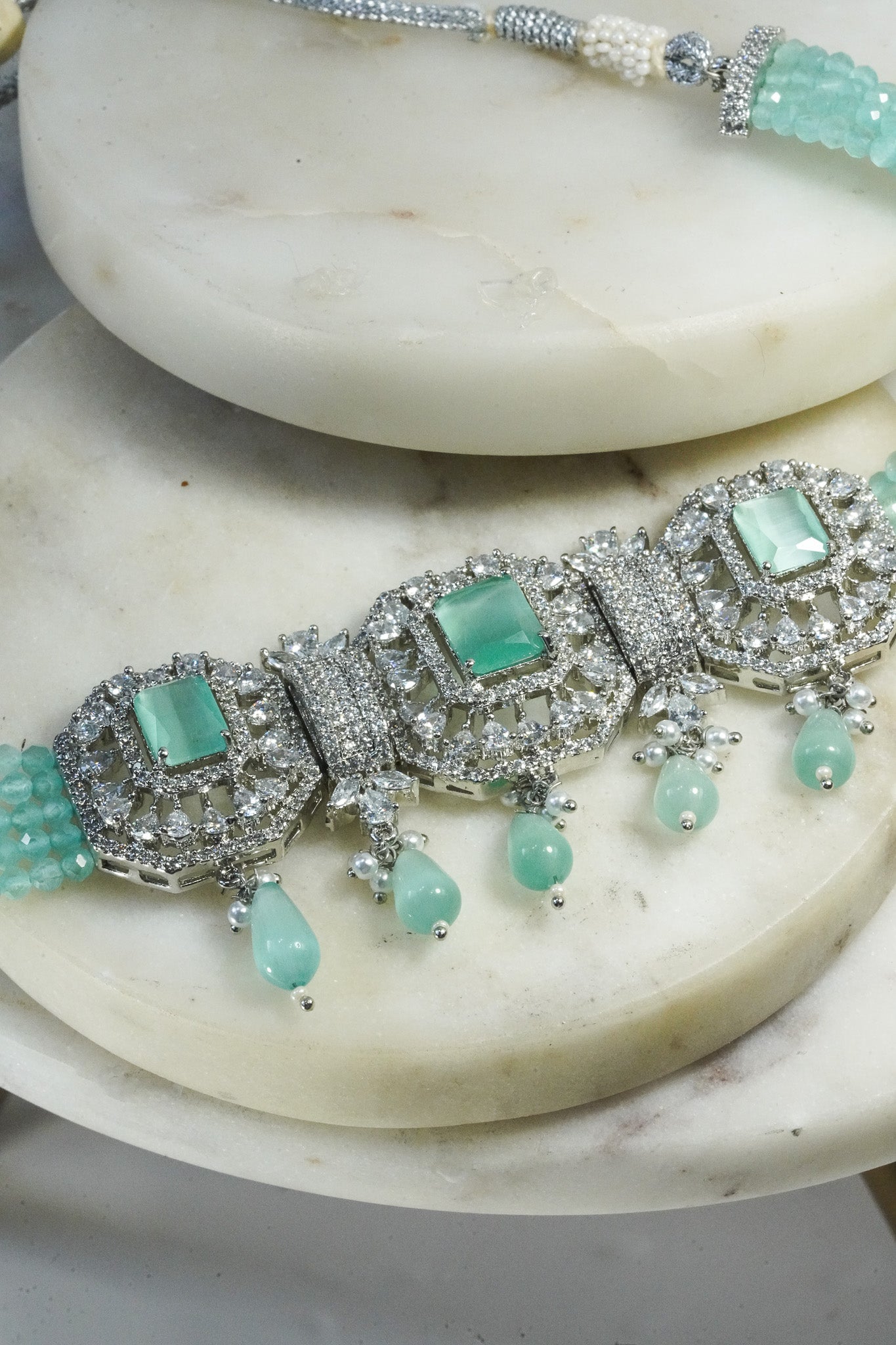 Jhanvi Choker Necklace Set - Silver & Gem Variations featuring cushion-cut AD stones with mint green teardrop accents, includes matching earrings.