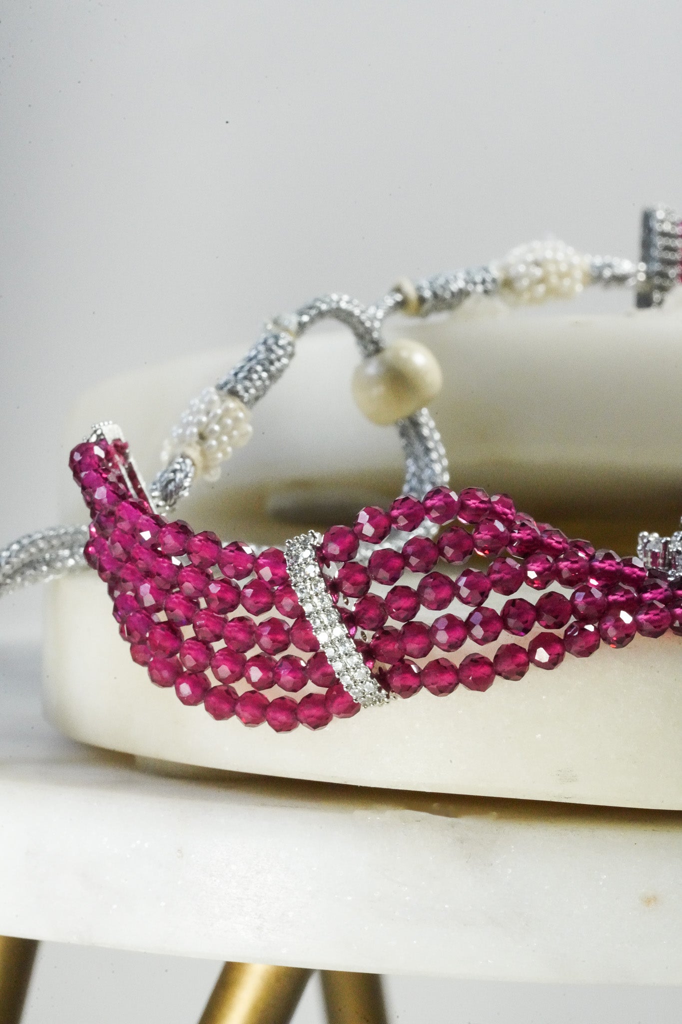 Jhanvi Choker Necklace Set - Silver & Gem Variations featuring cushion-cut AD stones with ruby teardrop accents, includes matching earrings.