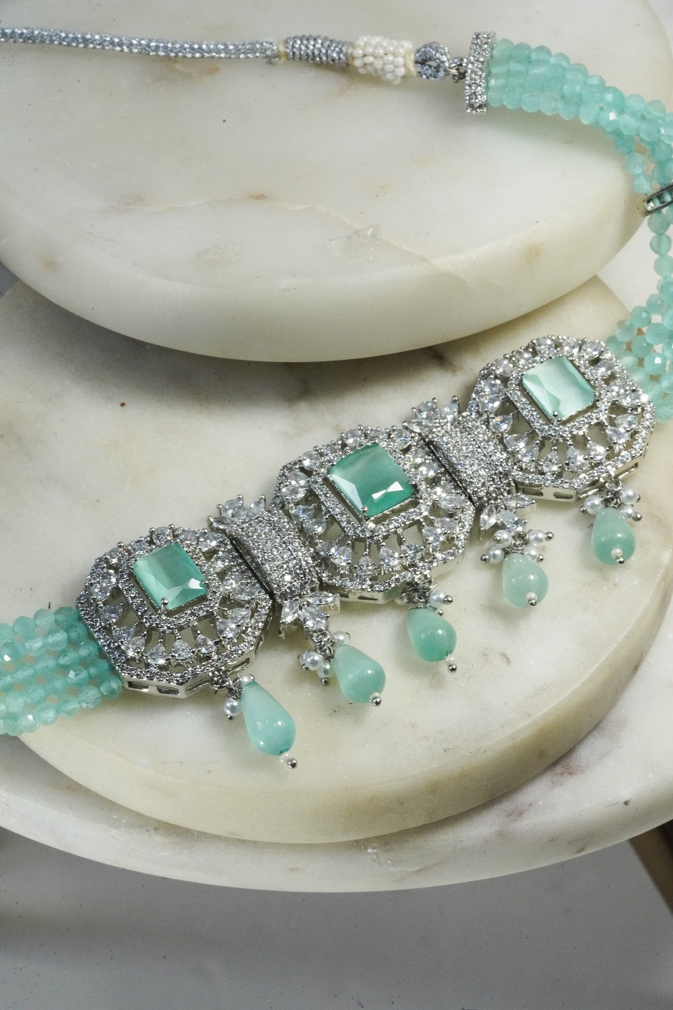 Jhanvi Choker Necklace Set - Silver & Gem Variations featuring cushion-cut AD stones with mint green teardrop accents, includes matching earrings.