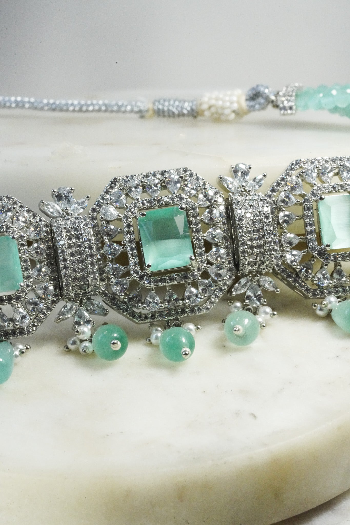 Jhanvi Choker Necklace Set - Silver & Gem Variations featuring cushion-cut AD stones with mint green teardrop accents, includes matching earrings.