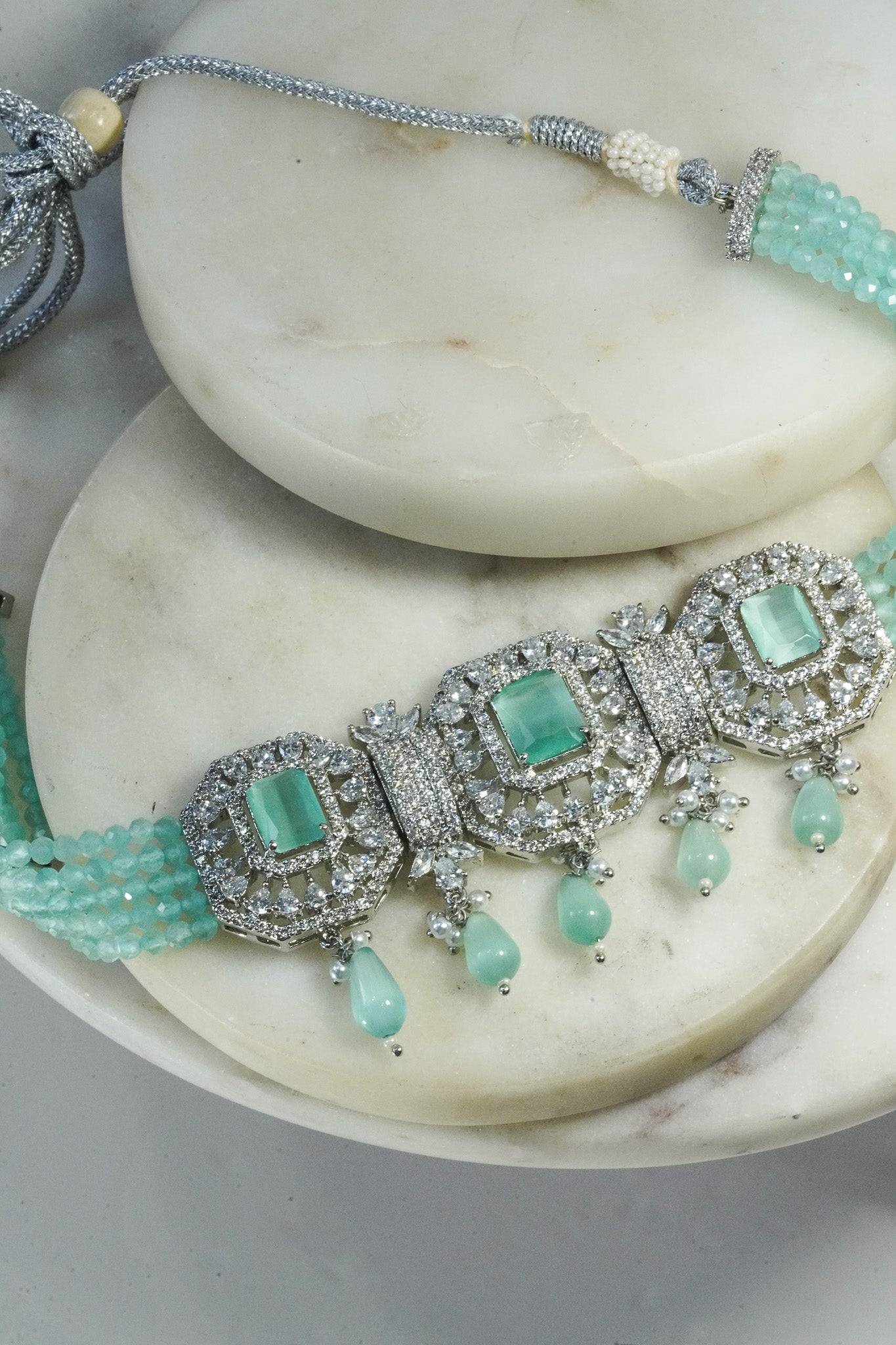 Jhanvi Choker Necklace Set - Silver & Gem Variations featuring cushion-cut AD stones with mint green teardrop accents, includes matching earrings.