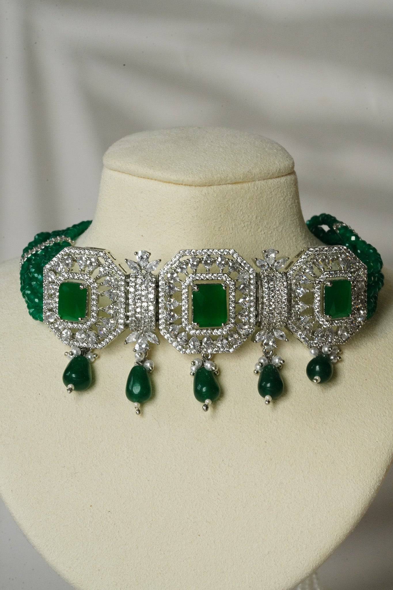 Jhanvi Choker Necklace Set - Silver & Gem Variations featuring cushion-cut AD stones with green teardrop accents, includes matching earrings.
