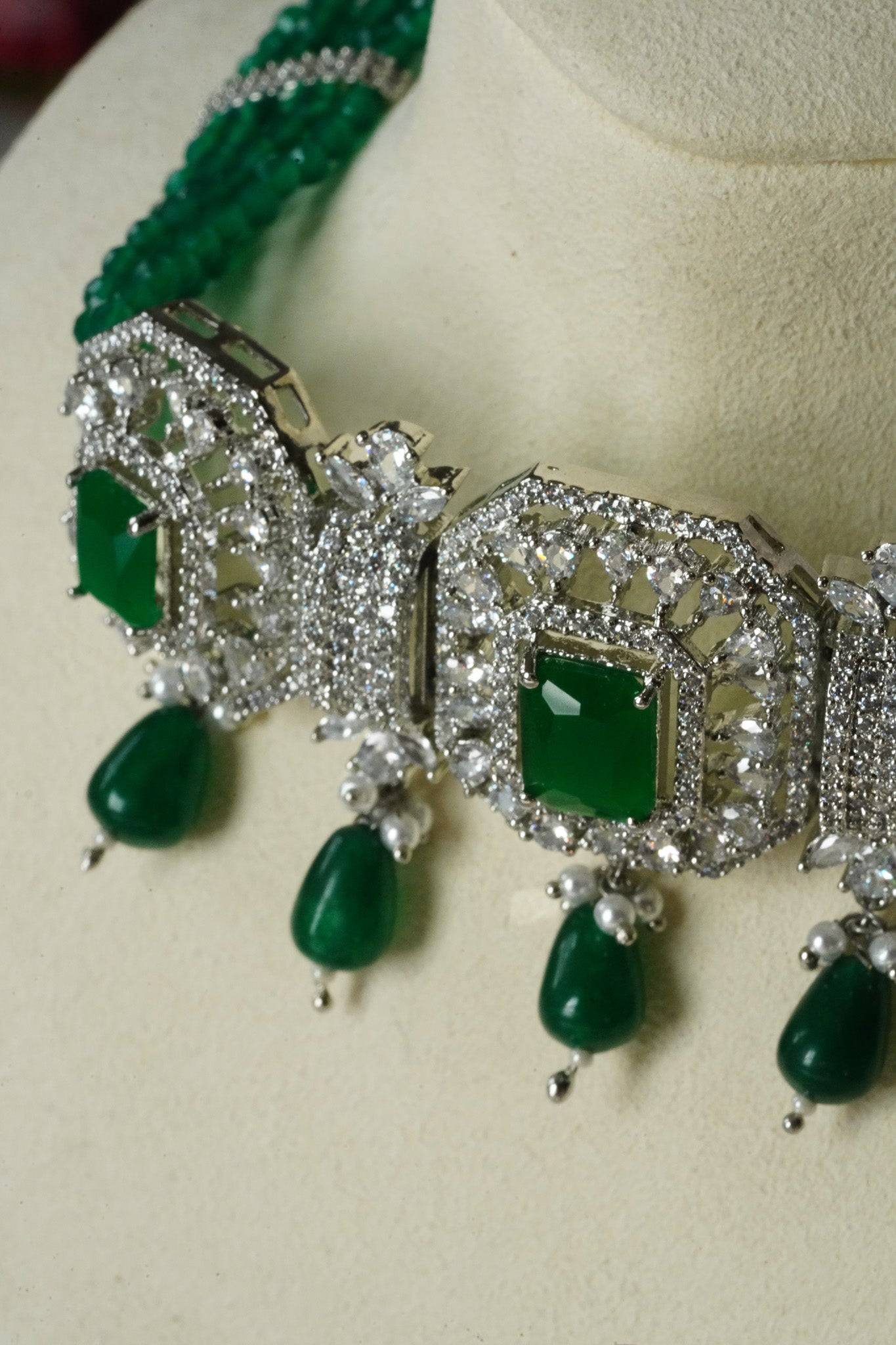Jhanvi Choker Necklace Set - Silver & Gem Variations featuring cushion-cut AD stones with green teardrop accents, includes matching earrings.