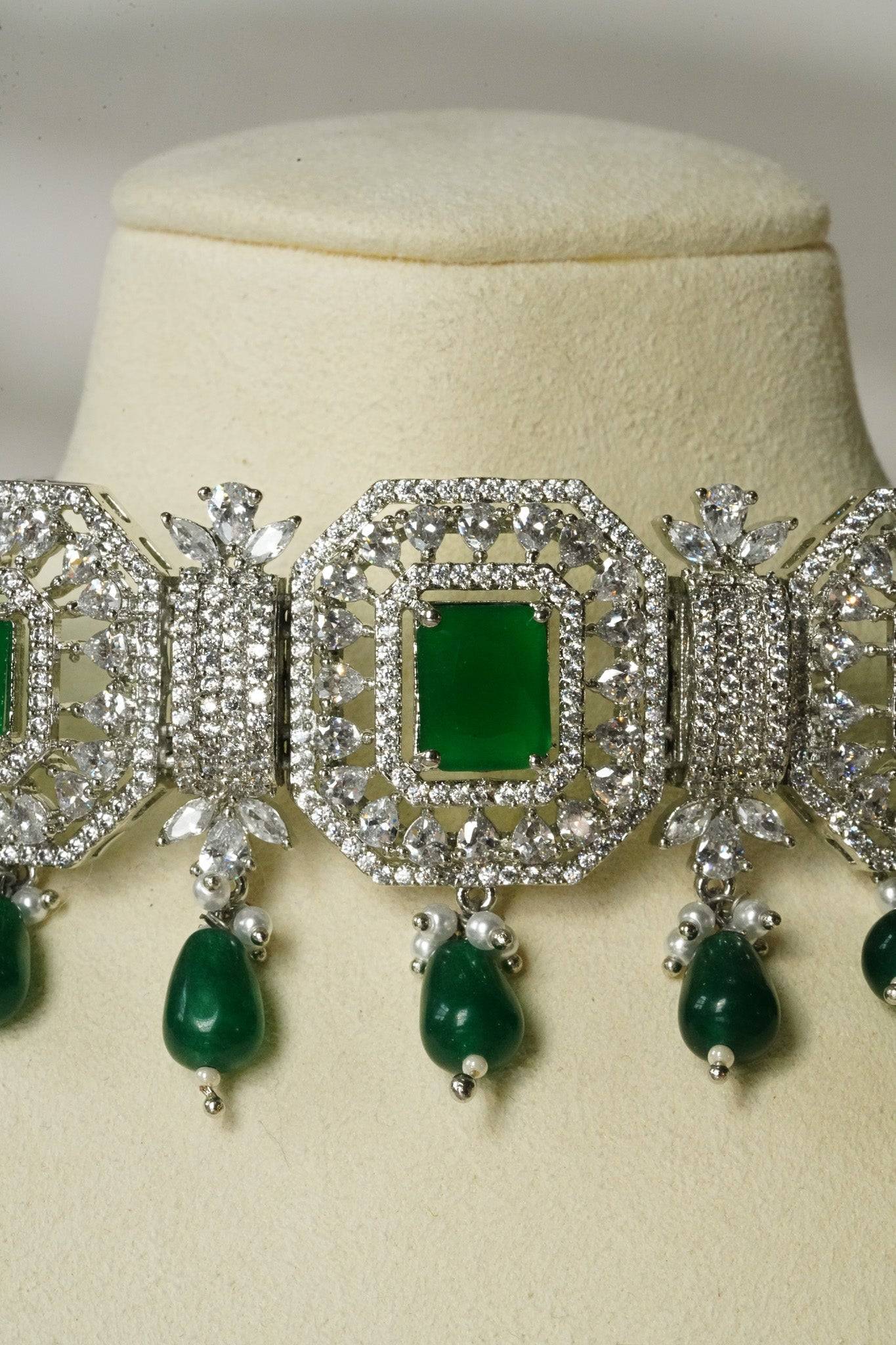 Jhanvi Choker Necklace Set - Silver & Gem Variations featuring cushion-cut AD stones with green teardrop accents, includes matching earrings.