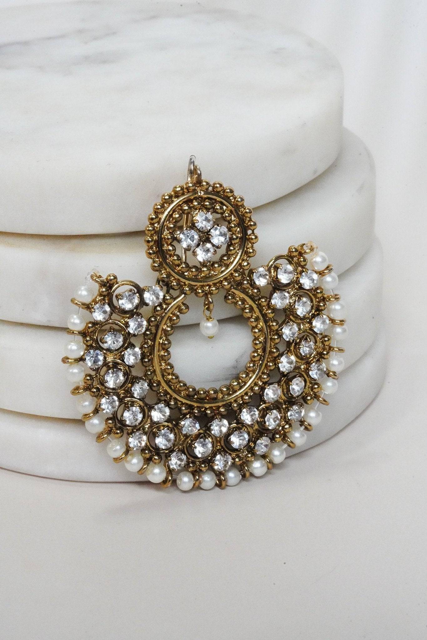 Front view of Laila Chandbali Earring in antique gold with intricate stonework and pearl accents, styled on marble.