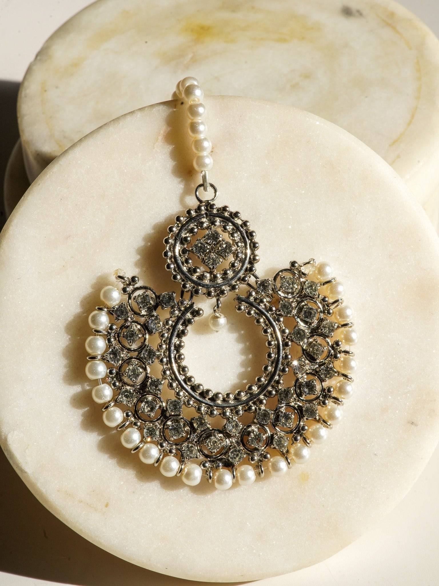 Detailed view of Laila Maang Tikka in antique gold with white stones and pearl trim, perfect for bridal or festive wear.