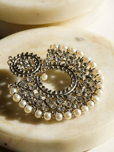 Close-up of Laila Chandbali Earrings in antique gold finish, featuring intricate white stonework and pearl accents for formal wear.