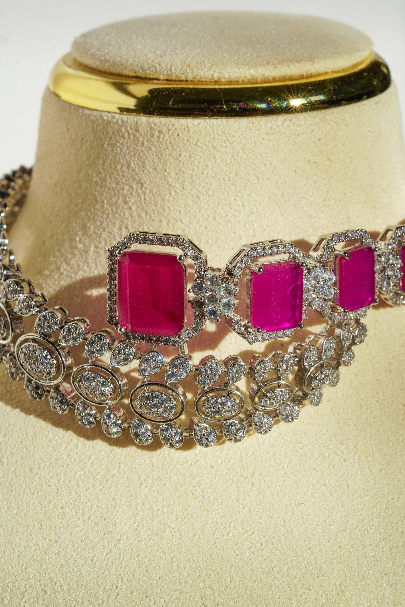 Mahi Asymmetrical Choker Necklace Set - Rhodium-plated with AD stones, available in silver & green, silver & ruby, and silver & sapphire blue, perfect for contemporary elegance.