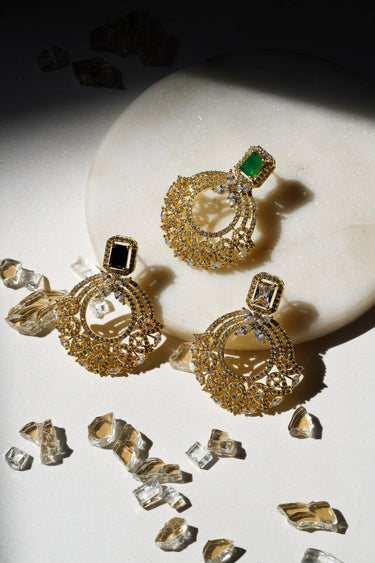 Set of The Mia - Dainty Chandbali Earrings with CZ Stones in green, white, and black, styled with crystal accents on a white marble base.
