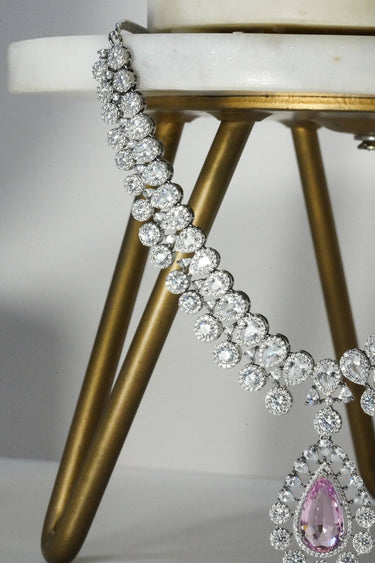 Detail of Mirah AD Necklace Set - Elegant Jewelry with pink teardrop pendant and CZ stones on silver chain.
