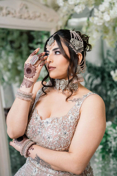 Model in bridal attire wearing Namar Silver Plated AD Indian Choker Necklace Set with matching accessories and mehndi.