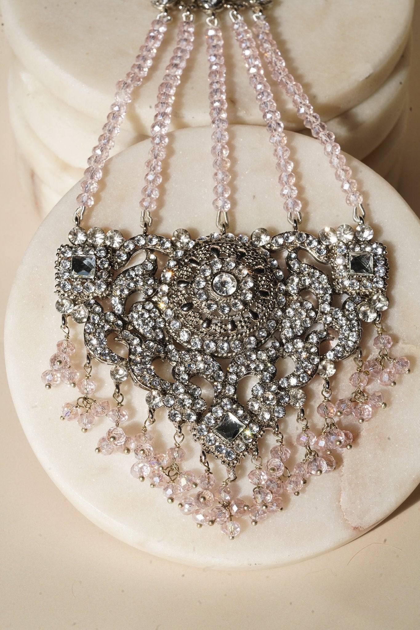 Close-up of Namar maang tikka with pink beads and CZ stones, part of the Indian choker necklace set.