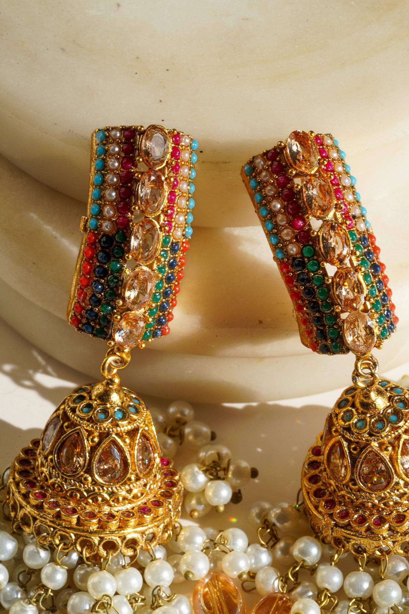 Navdeep Jhumka Earrings - Handcrafted with antique gold plating, available in ruby, blue, or gold, featuring multi-color stones and embellishments.