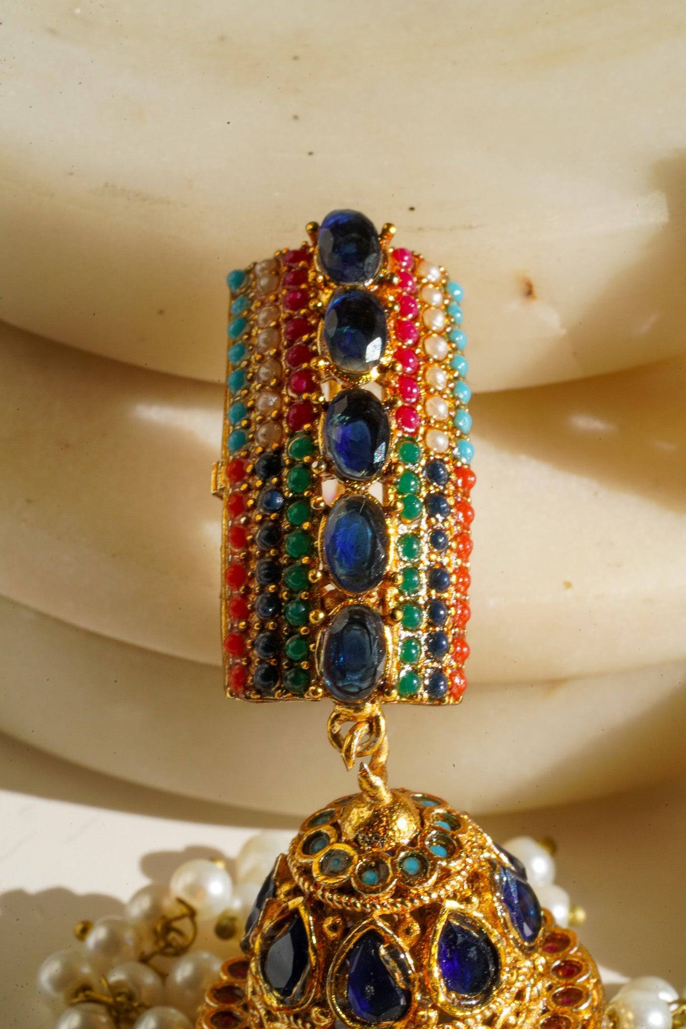 Navdeep Jhumka Earrings - Handcrafted with antique gold plating, available in ruby, blue, or gold, featuring multi-color stones and embellishments.