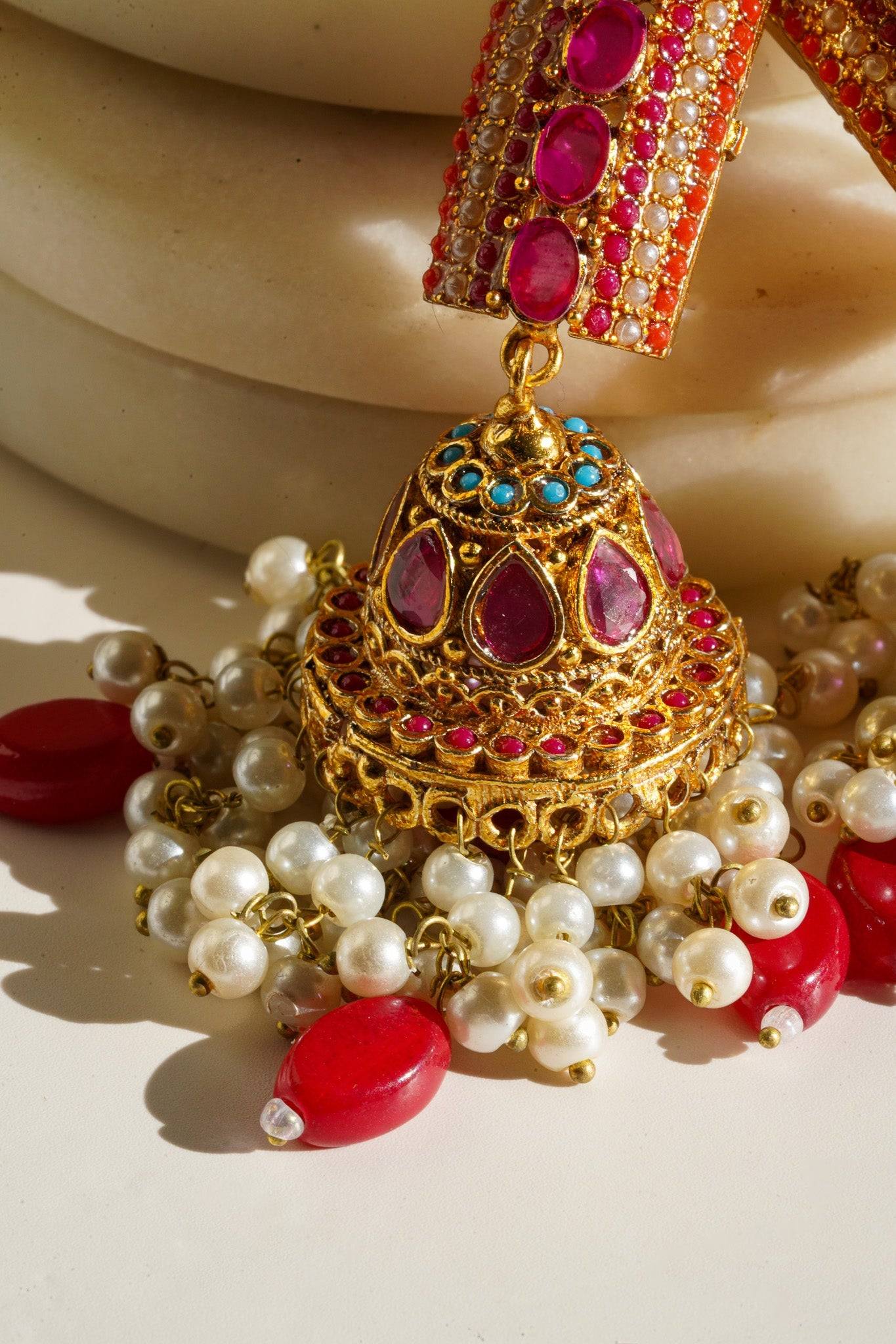 Navdeep Jhumka Earrings - Handcrafted with antique gold plating, available in ruby, blue, or gold, featuring multi-color stones and embellishments.