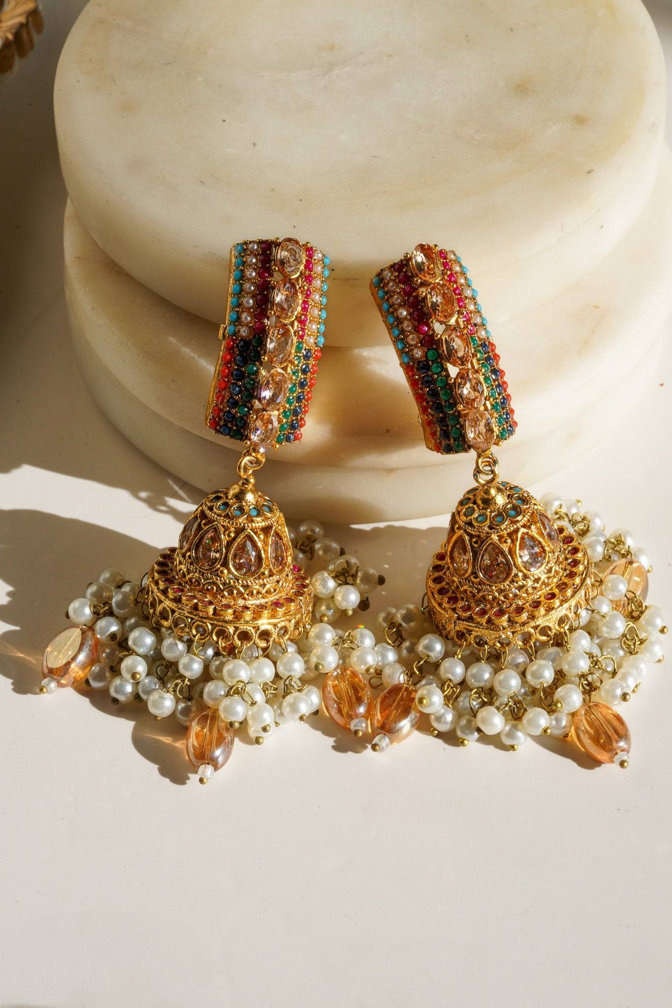 Navdeep Jhumka Earrings - Handcrafted with antique gold plating, available in ruby, blue, or gold, featuring multi-color stones and embellishments.