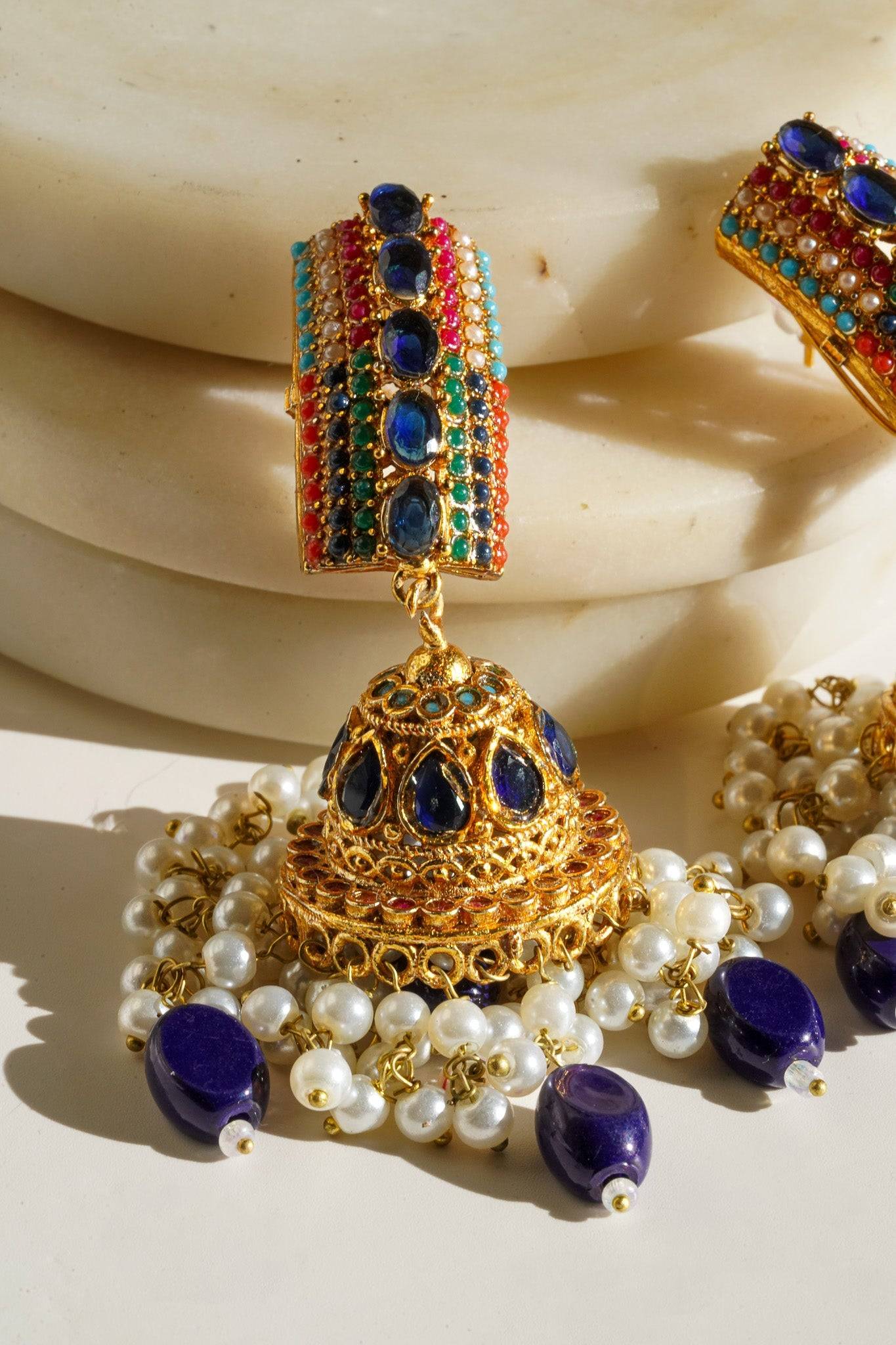Navdeep Jhumka Earrings - Handcrafted with antique gold plating, available in ruby, blue, or gold, featuring multi-color stones and embellishments.