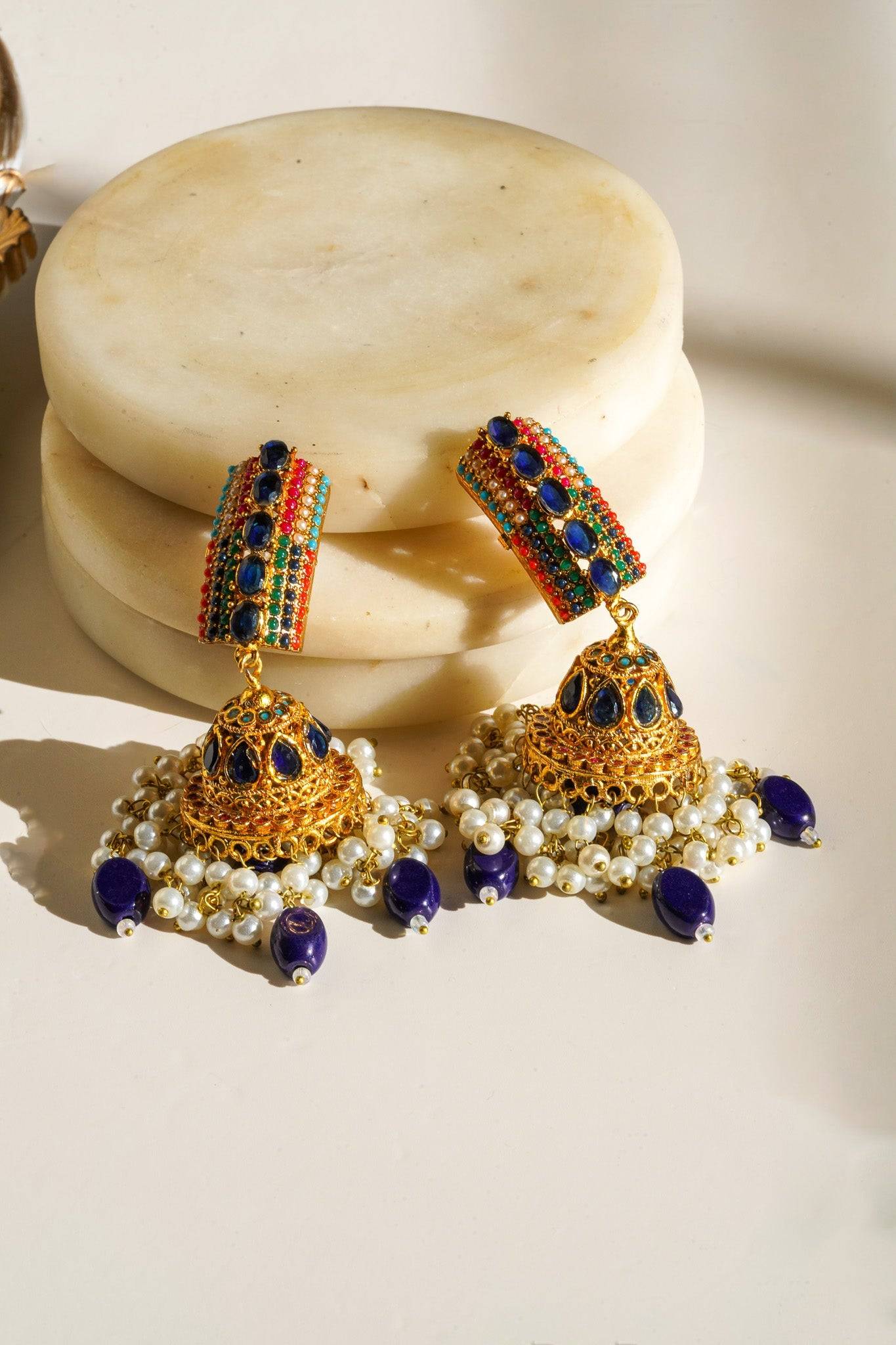 Navdeep Jhumka Earrings - Handcrafted with antique gold plating, available in ruby, blue, or gold, featuring multi-color stones and embellishments.