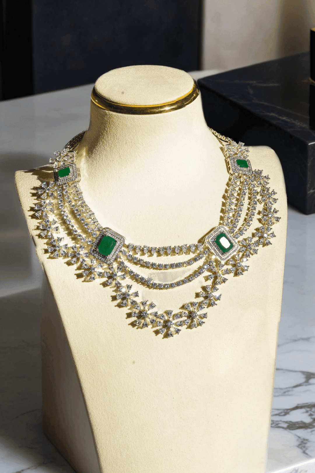 Neha Diamanté Accent Classic Necklace Set - Rhodium-plated with ruby or green accents, floral pattern, curvy layers, and matching 2-inch earrings.