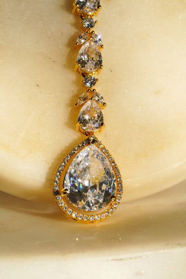 Nila Diamanté Accent Golden AD Maang Tikka - Gold-plated with teardrop stones and diamante accents, available in gold & multicolor or gold & white.