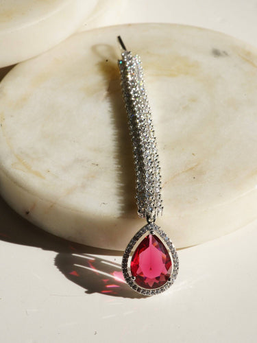 Rhodium-plated maang tikka with white American Diamonds and a maroon teardrop accent from Inaury