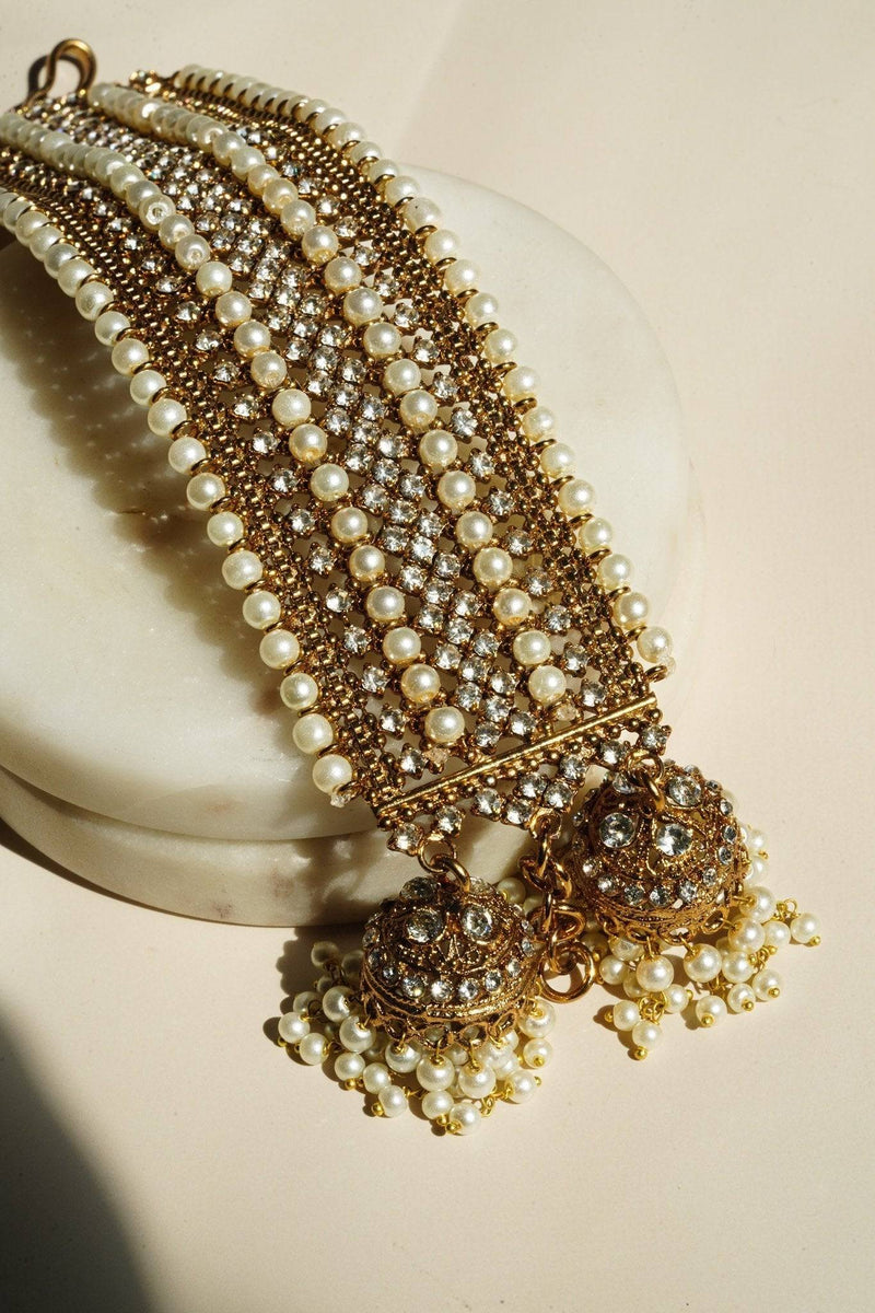 Elegant Adjustable Samia Bangles in gold with pearl and CZ stone detailing, featuring two ornate jhumkas, artisan-crafted Pakistani jewelry.