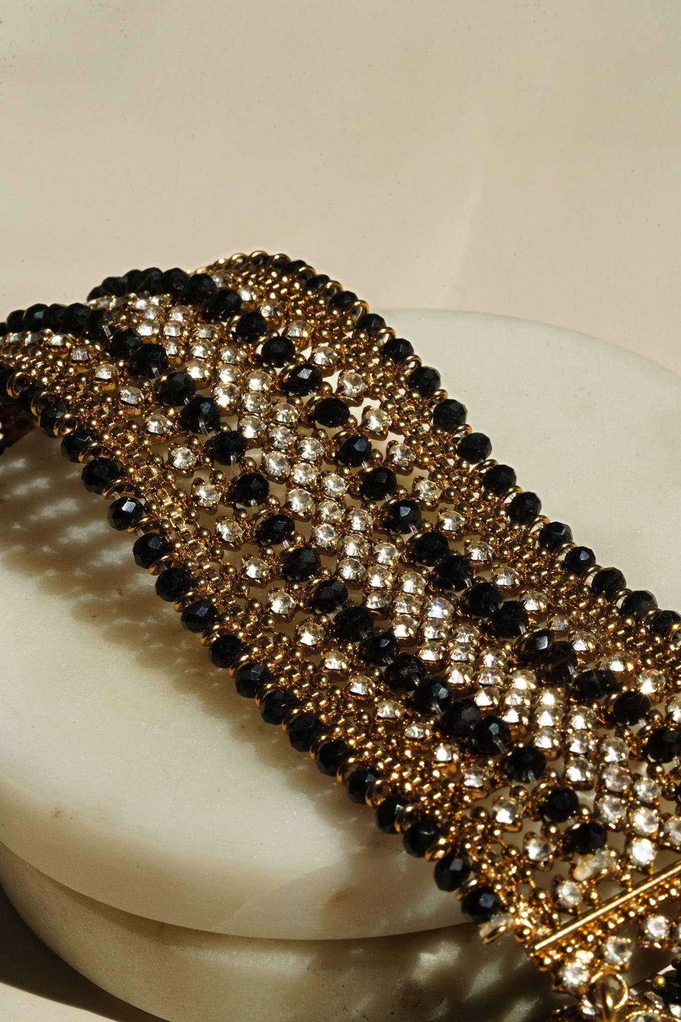 Close-up of Samia Bangles in gold with black beads and CZ stones, offering a bold contrast and elegant traditional style.