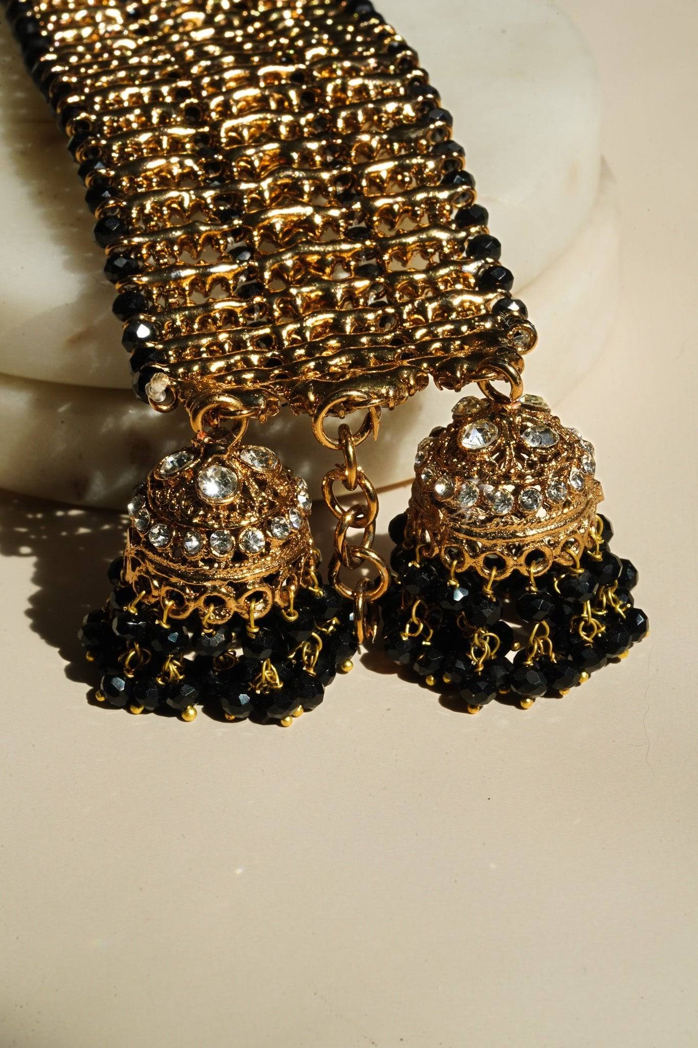 Jhumka detail of Samia Bangles in gold with black bead tassels and CZ stones, showcasing ornate traditional jewelry elements.