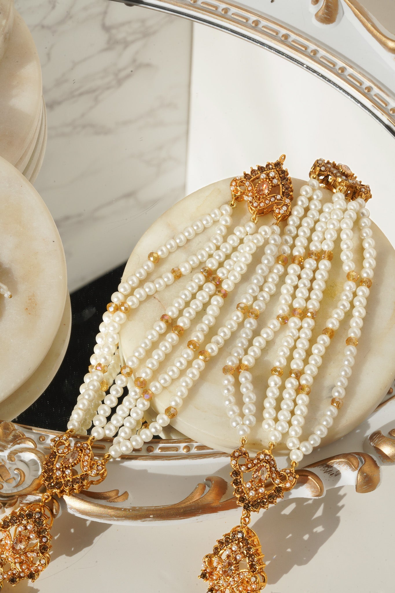 Detailed gold and pearl Maang Tikka from Sanjana Jewelry Set, ideal for traditional South Asian celebrations.
