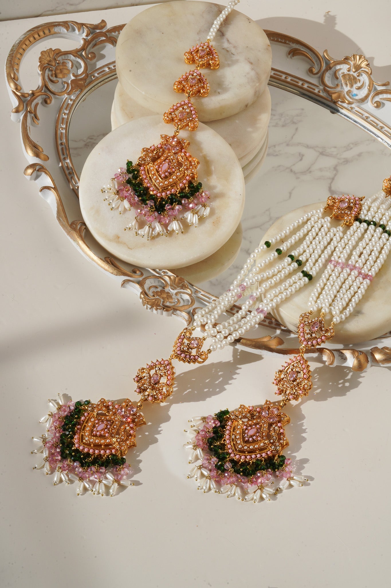 Elegant Sanjana Earrings & Tikka Set with pink stones and pearl embellishments, ideal for ethnic and festive outfits.