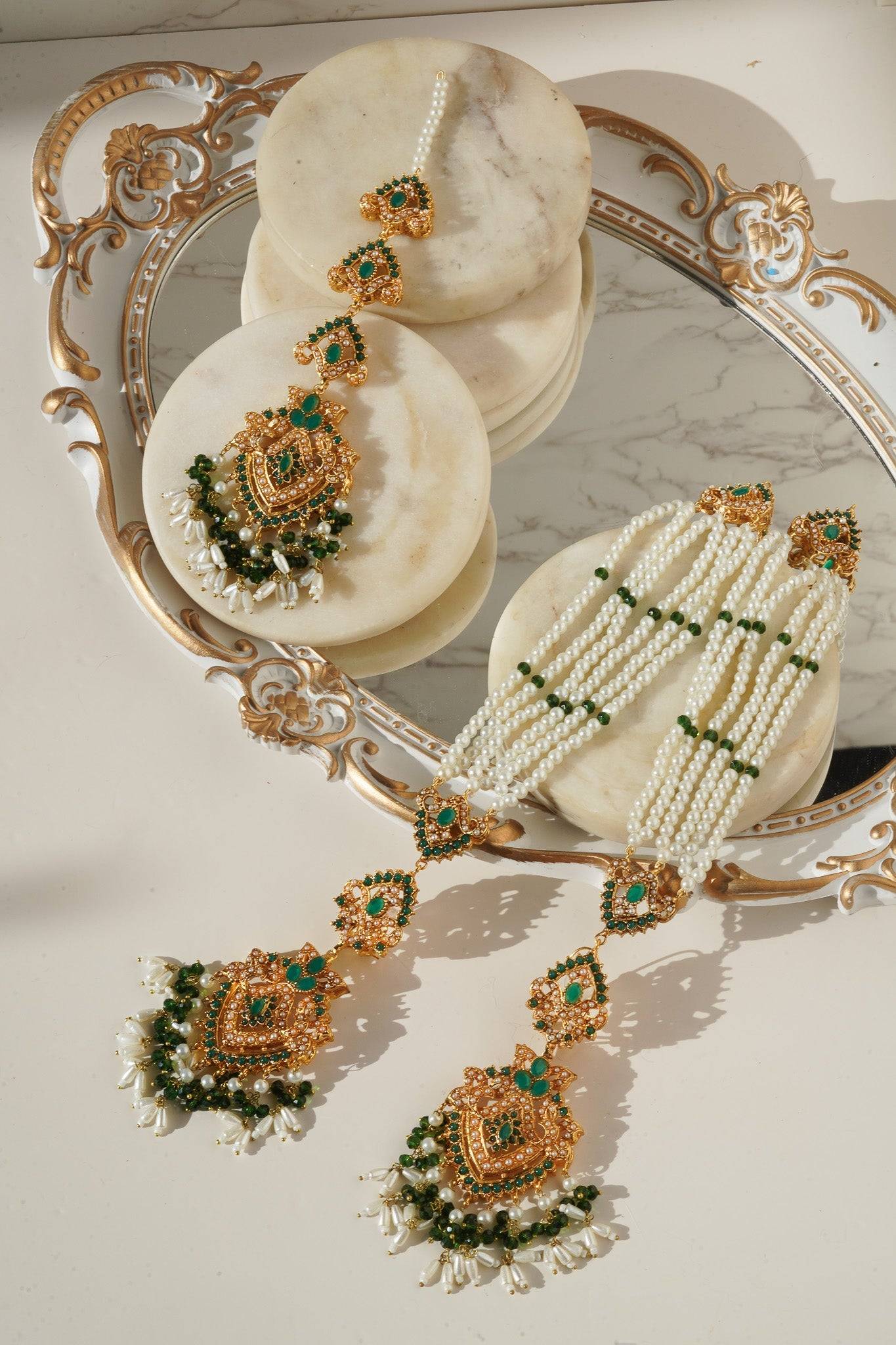 Sanjana Earrings and Maang Tikka Set with green stones and pearl strands, combining traditional design with modern elegance.