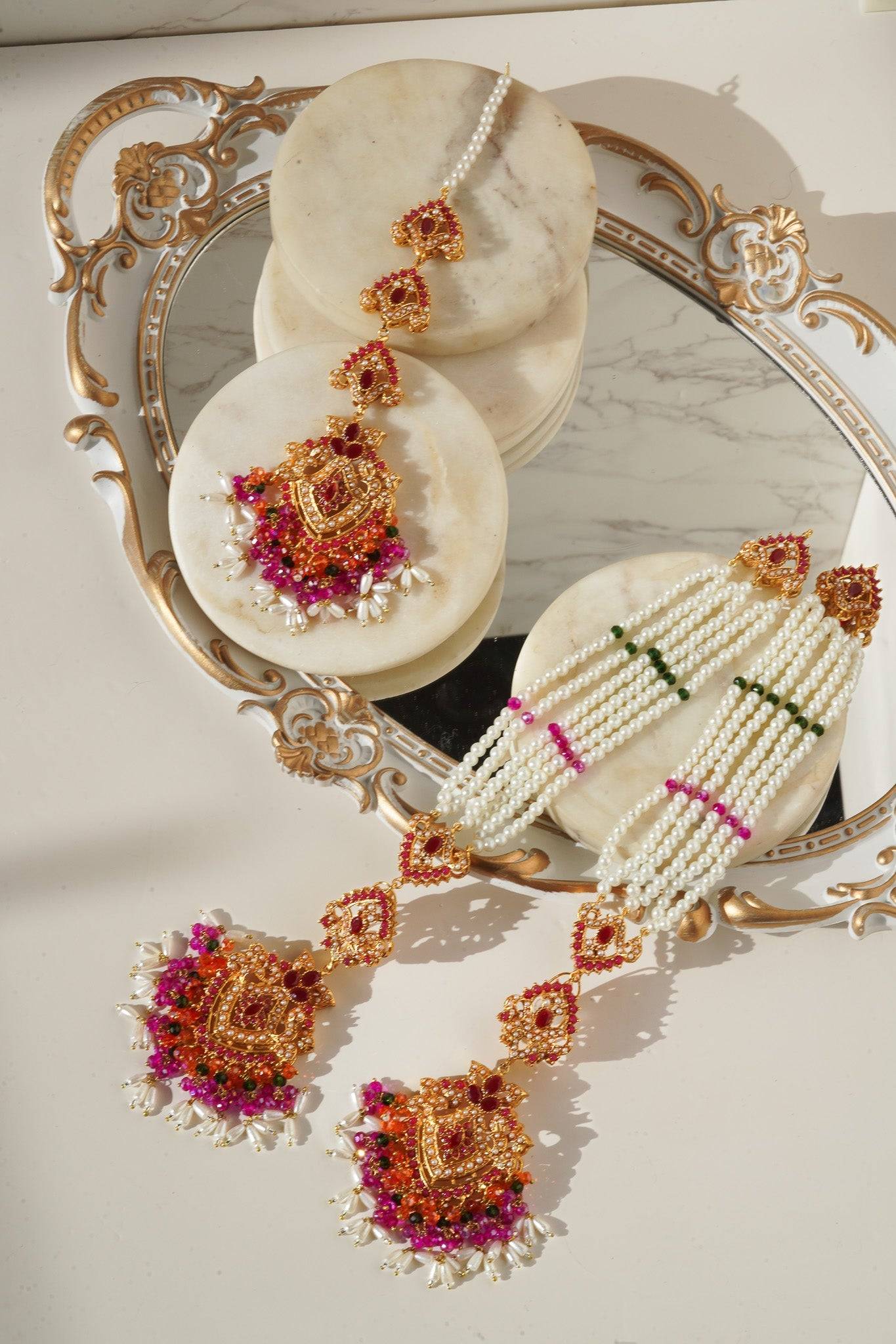 Sanjana Earrings and Maang Tikka Set with multicolor Navratan stones and pearls, ideal for festive and bridal looks.