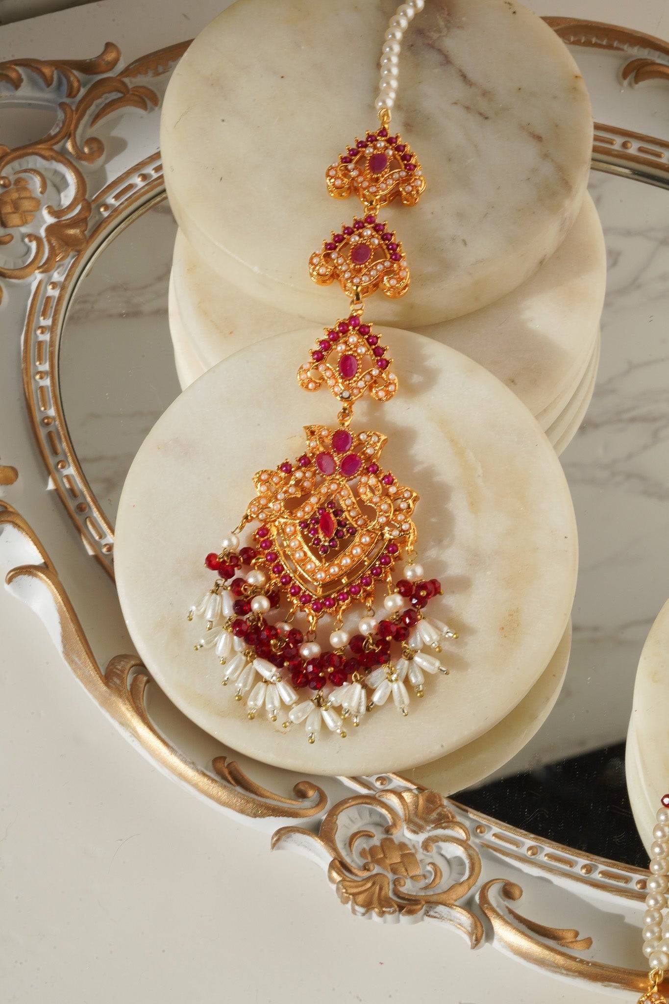 Maang Tikka from Sanjana Set with red stones and pearl fringe, ideal for weddings and cultural celebrations.