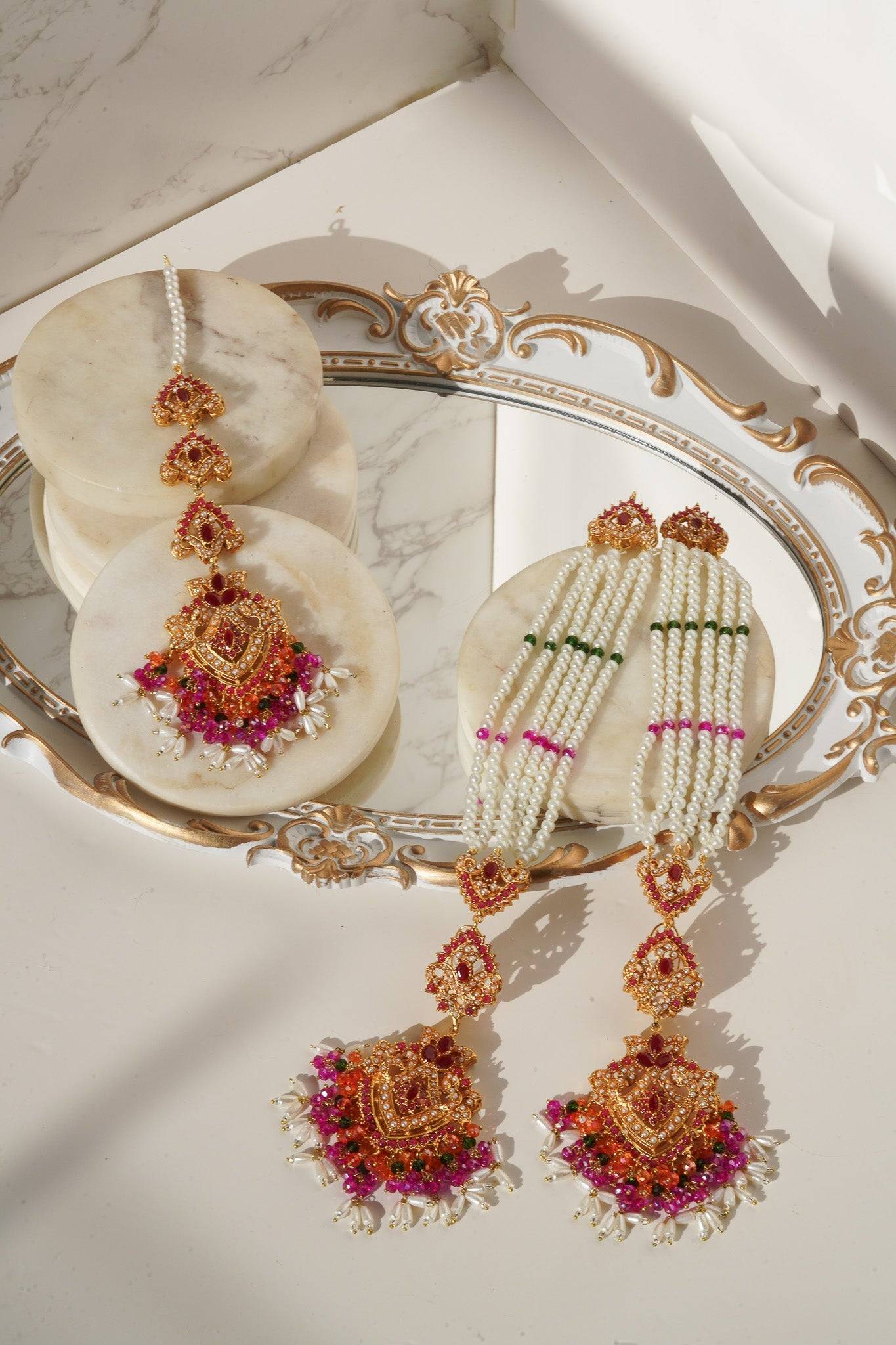Multicolor Sanjana Jewelry Set with pink, green, and orange stones, pearl strands, and gold detailing for ethnic wear.