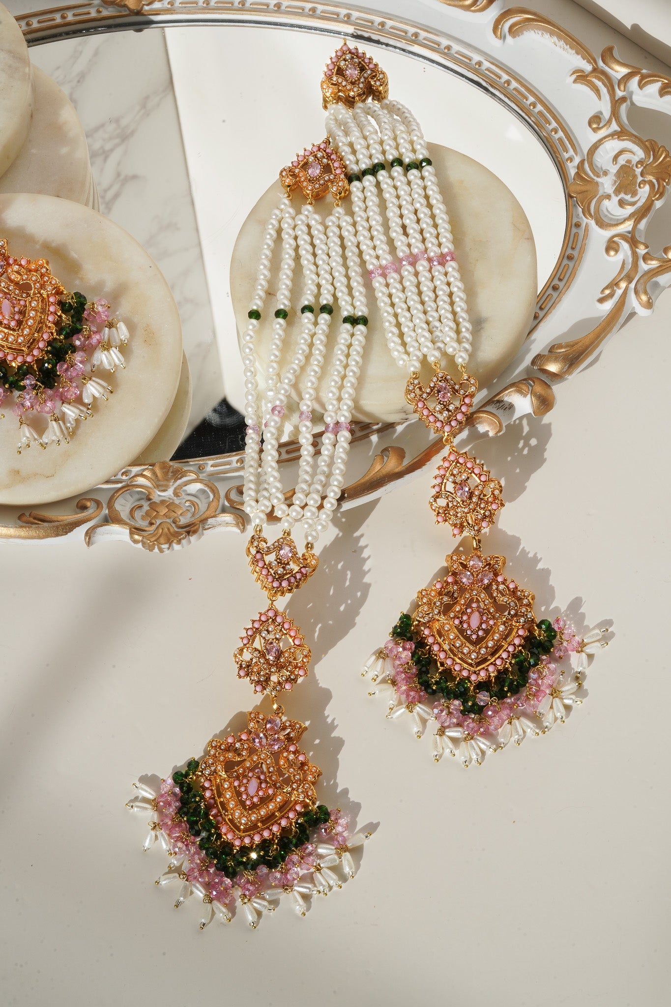 Detailed view of pink and green Sanjana Jewelry Set with pearls and goldwork, perfect for traditional occasions.