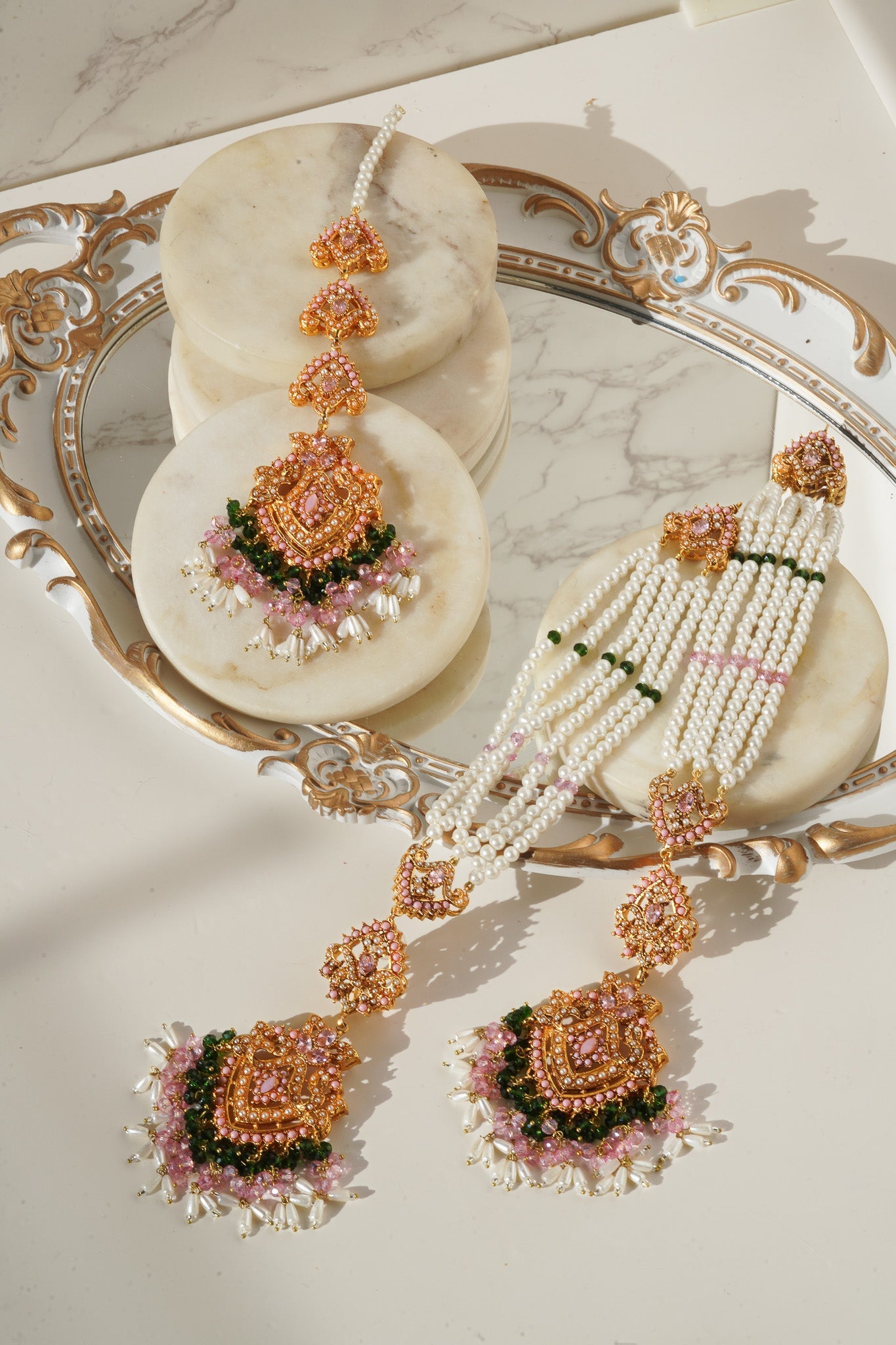 Pink and green Sanjana Jewelry Set with pearls and gold detailing, showcasing South Asian bridal elegance.