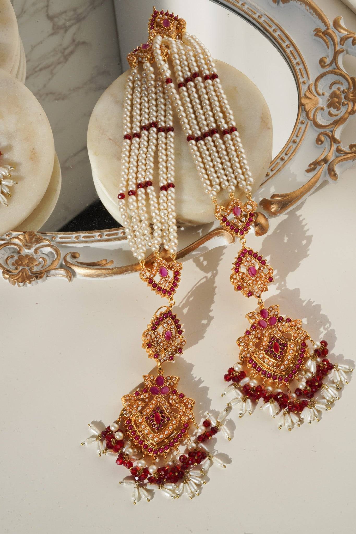 Red and pearl Sanjana Earrings & Tikka Set with intricate goldwork, designed for ethnic and bridal wear.