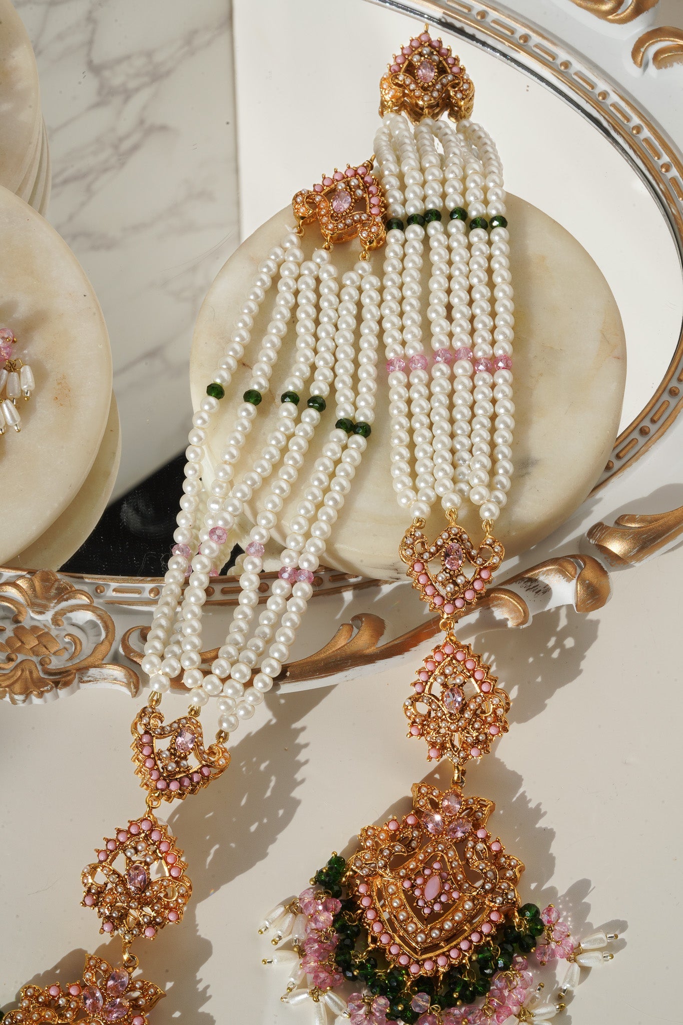 Sanjana Earrings and Maang Tikka Set in gold and white with pearl strands, ideal for elegant bridal and festive looks.