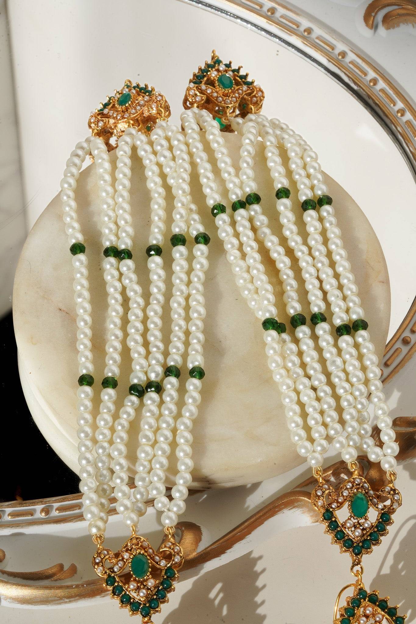Pearl strands with green accents from Sanjana Jewelry Set, showcasing detailed craftsmanship and traditional aesthetics.