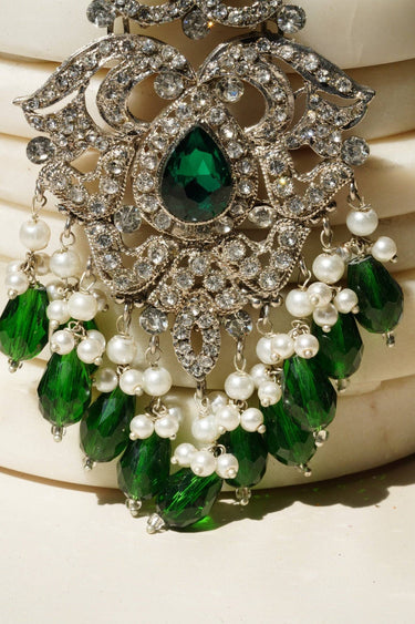 Zoomed-in shot of Sidra Chandelier Earrings' lower section, highlighting green crystal beads and faux pearl strands in a luxe finish.