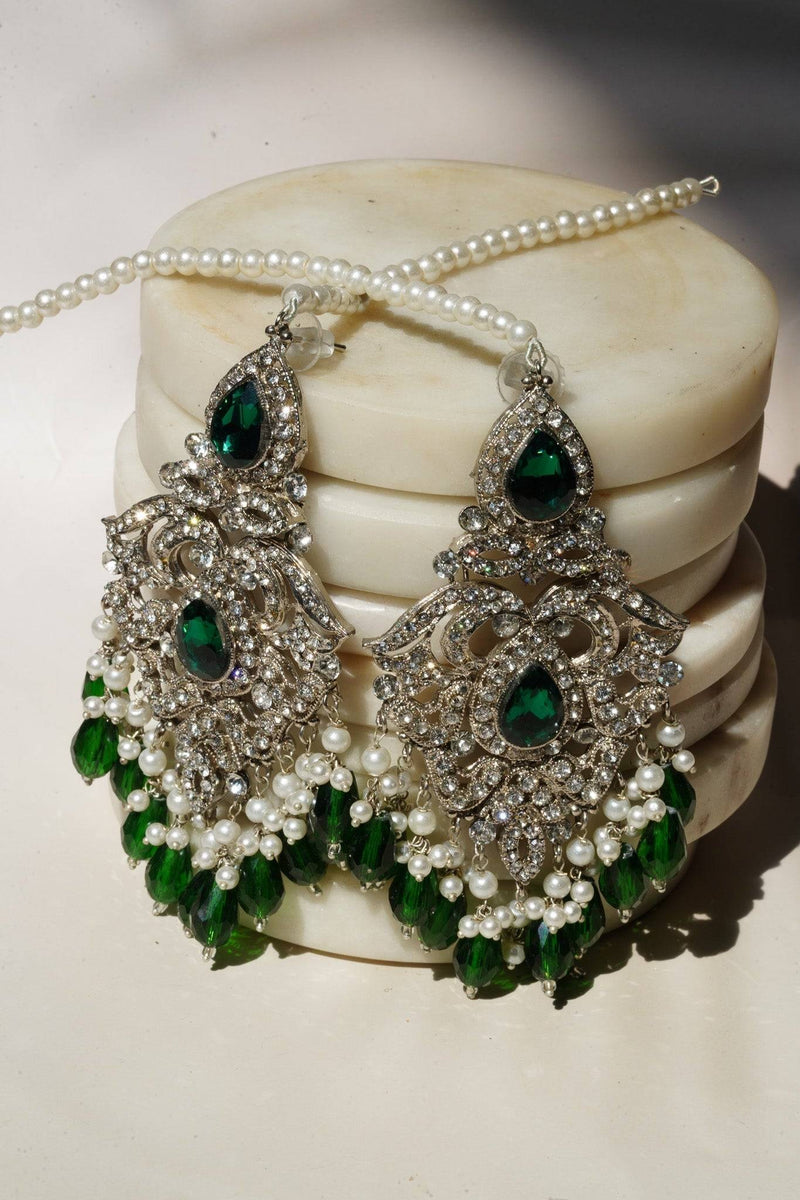 Pakistani Jewelry - Sidra Chandelier Dangler Earrings in silver with green CZ stones and faux pearls, featuring a 4-inch drop and intricate detailing.