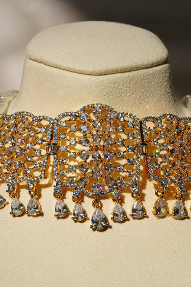 Close-up of Sumra Choker Necklace centerpiece with cubic zirconia and gold finish. Intricate design for a glamorous look.
